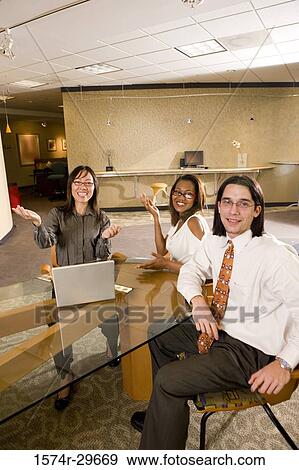 Portrait of businessman and businesswomen sitting in office View Large Photo Image Stock Photo - Portrait of businessman and businesswomen sitting in office. Fotosearch