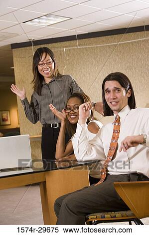 Portrait of businessman and businesswomen sitting in office View Large Photo Image Stock Photography - Portrait of businessman and businesswomen sitting in office. Fotosearch