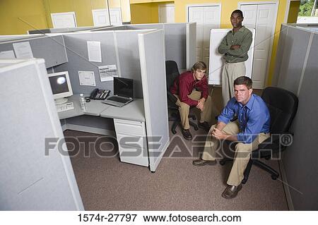 Stock Photo - Portrait of businessmen by chart board in an office. Fotosearch