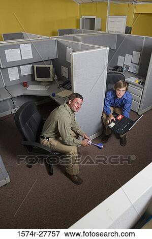 Stock Photo - Portrait of businessmen sitting in an office. Fotosearch