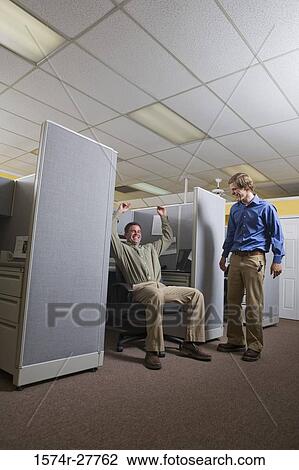 Stock Image - Portrait of businessmen smiling in an office. Fotosearch