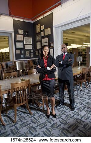 Portrait of businesspeople standing in an office View Large Photo Image Picture - Portrait of businesspeople standing in an office. Fotosearch