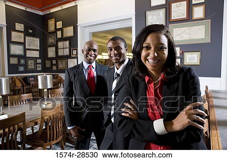 Portrait of businesspeople standing in an office View Large Photo Image Stock Image - Portrait of businesspeople standing in an office. Fotosearch