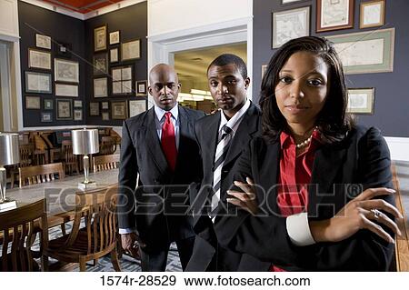 Portrait of businesspeople standing in an office View Large Photo Image Stock Photo - Portrait of businesspeople standing in an office. Fotosearch