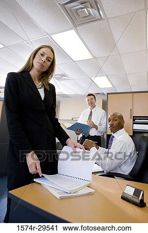 Portrait of businesswoman holding a book with colleagues View Large Photo Image Stock Image - Portrait of businesswoman holding a book with colleagues. Fotosearch