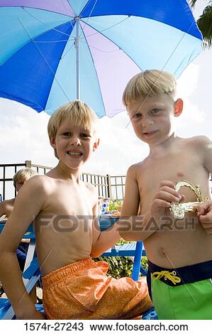 Portrait of cheerful boys holding toy View Large Photo Image Stock Image - Portrait of cheerful boys holding toy. Fotosearch