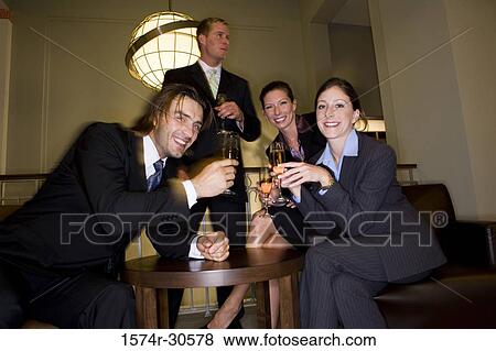 Portrait of cheerful business people celebrating in an office View Large Photo Image Stock Photo - Portrait of cheerful business people celebrating in an office. Fotosearch
