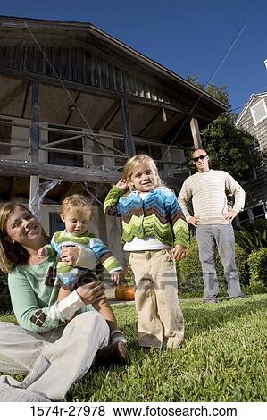 Portrait of cheerful family in front of a house View Large Photo Image Stock Photo - Portrait of cheerful family in front of a house. Fotosearch