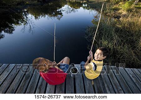 Portrait of cheerful friends fishing with fishing rods at the lake View Large Photo Image Stock Photo - Portrait of cheerful friends fishing with fishing rods at the lake. Fotosearch