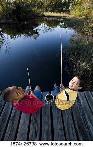 Portrait of cheerful friends fishing with fishing rods at the lake View Large Photo Image Stock Photo - Portrait of cheerful friends fishing with fishing rods at the lake. Fotosearch