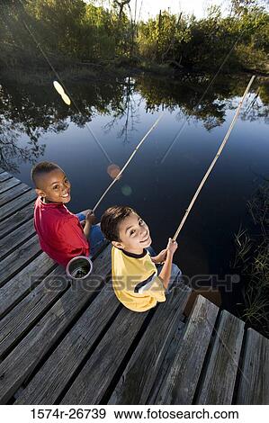 Portrait of cheerful friends fishing with fishing rods at the lake View Large Photo Image Stock Photo - Portrait of cheerful friends fishing with fishing rods at the lake. Fotosearch