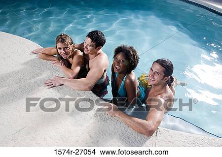 Portrait of cheerful friends in swimming pool View Large Photo Image Picture - Portrait of cheerful friends in swimming pool. Fotosearch