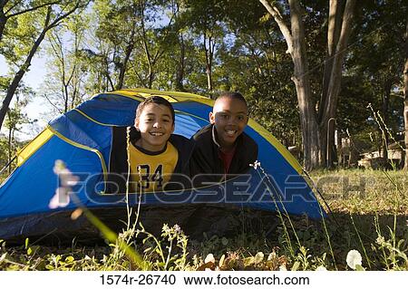 Portrait of cheerful friends looking through tent at forest View Large Photo Image Stock Image - Portrait of cheerful friends looking through tent at forest. Fotosearch