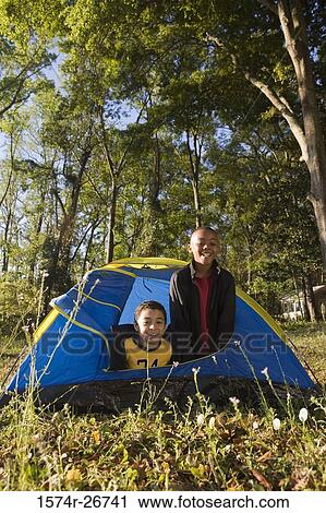 Portrait of cheerful friends looking through tent at forest View Large Photo Image Stock Image - Portrait of cheerful friends looking through tent at forest. Fotosearch