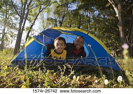 Portrait of cheerful friends looking through tent at forest View Large Photo Image Stock Image - Portrait of cheerful friends looking through tent at forest. Fotosearch