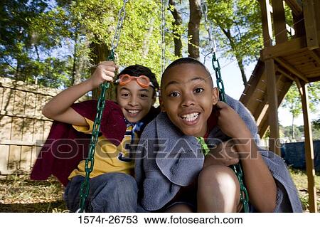 Portrait of cheerful friends playing with swing at forest View Large Photo Image Stock Image - Portrait of cheerful friends playing with swing at forest. Fotosearch