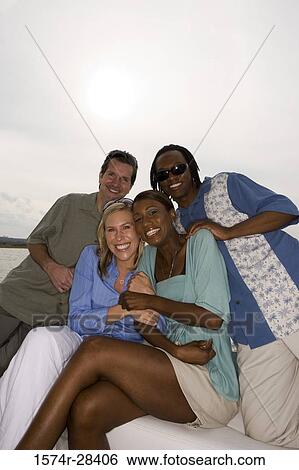 Portrait of cheerful friends sitting together View Large Photo Image Stock Photograph - Portrait of cheerful friends sitting together. Fotosearch