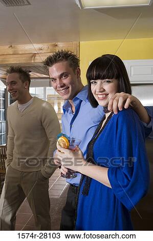 Portrait of cheerful friends standing in domestic kitchen with wines View Large Photo Image Stock Image - Portrait of cheerful friends standing in domestic kitchen with wines. Fotosearch