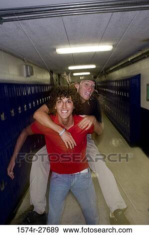 Portrait of cheerful male student piggy backing friend View Large Photo Image Stock Photo - Portrait of cheerful male student piggy backing friend. Fotosearch