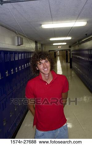 Portrait of cheerful male student standing by lockers View Large Photo Image Stock Photo - Portrait of cheerful male student standing by lockers. Fotosearch