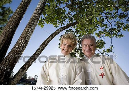 Stock Photography - Portrait of cheerful mature couple wearing sports clothing. Fotosearch