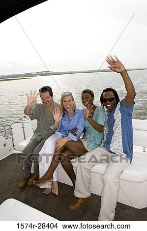 Picture - Portrait of cheerful mid adult couples waving in the boat. Fotosearch