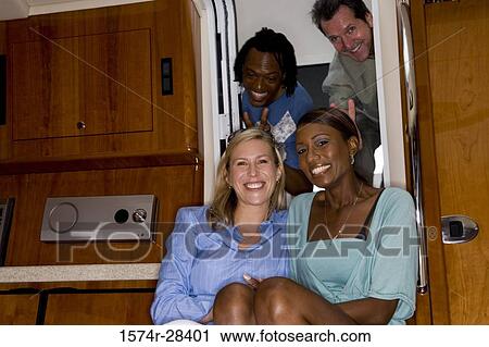 Portrait of cheerful mid adult couples enjoying in the boat View Large Photo Image Stock Image - Portrait of cheerful mid adult couples enjoying in the boat. Fotosearch