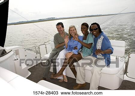 Portrait of cheerful mid adult couples enjoying in the boat View Large Photo Image Stock Image - Portrait of cheerful mid adult couples enjoying in the boat. Fotosearch