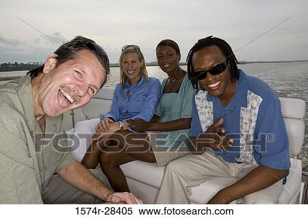 Portrait of cheerful mid adult couples enjoying in the boat View Large Photo Image Stock Photography - Portrait of cheerful mid adult couples enjoying in the boat. Fotosearch