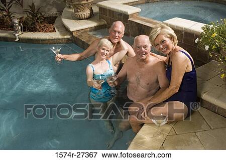 Portrait of cheerful senior couples with wineglasses at swimming pool View Large Photo Image Stock Photo - Portrait of cheerful senior couples with wineglasses at swimming pool. Fotosearch