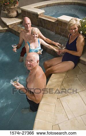 Portrait of cheerful senior couples with wineglasses at swimming pool View Large Photo Image Stock Photograph - Portrait of cheerful senior couples with wineglasses at swimming pool. Fotosearch