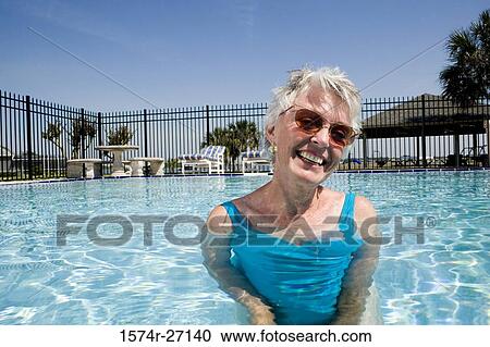 Portrait of cheerful senior woman in swimming pool View Large Photo Image Stock Image - Portrait of cheerful senior woman in swimming pool. Fotosearch