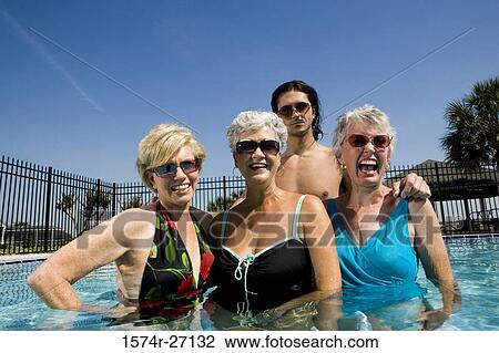 Portrait of cheerful senior women and young man standing in swimming pool View Large Photo Image Stock Image - Portrait of cheerful senior women and young man standing in swimming pool. Fotosearch
