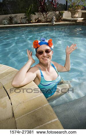 Portrait of cheerful senior women sitting in swimming pool View Large Photo Image Stock Image - Portrait of cheerful senior women sitting in swimming pool. Fotosearch