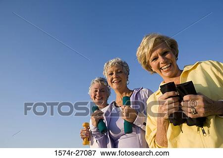 Portrait of cheerful senior women holding dumbbells View Large Photo Image Stock Photo - Portrait of cheerful senior women holding dumbbells. Fotosearch