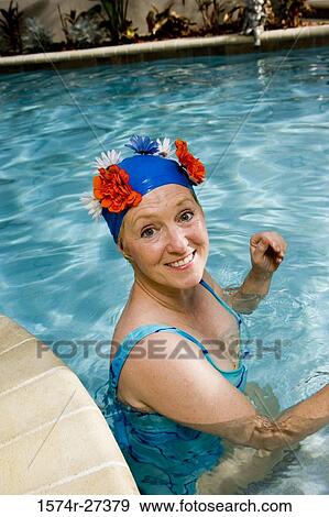 Portrait of cheerful senior women sitting in swimming pool View Large Photo Image Stock Photo - Portrait of cheerful senior women sitting in swimming pool. Fotosearch