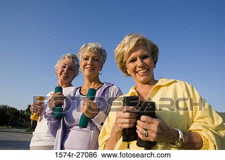 Portrait of cheerful senior women holding dumbbells View Large Photo Image Stock Photograph - Portrait of cheerful senior women holding dumbbells. Fotosearch