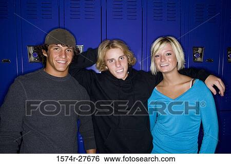 Portrait of cheerful students standing in front of lockers View Large Photo Image Stock Photograph - Portrait of cheerful students standing in front of lockers. Fotosearch