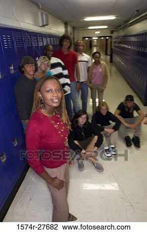 Portrait of cheerful students with female teacher standing by lockers View Large Photo Image Stock Image - Portrait of cheerful students with female teacher standing by lockers. Fotosearch