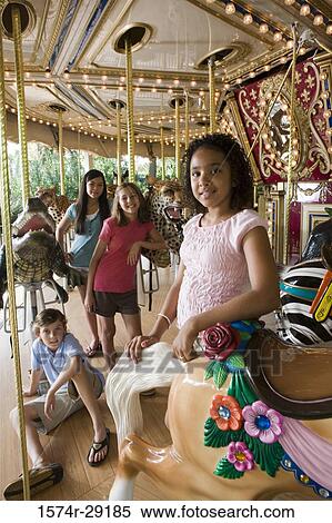 Portrait of cheerful teenagers standing in a carousel View Large Photo Image Stock Photography - Portrait of cheerful teenagers standing in a carousel. Fotosearch