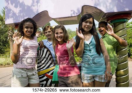 Portrait of cheerful teenagers standing together and waving hands View Large Photo Image Stock Photography - Portrait of cheerful teenagers standing together and waving hands. Fotosearch