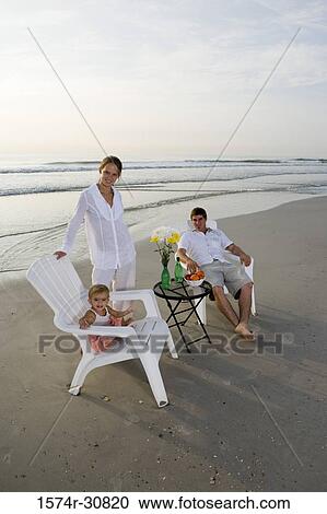 Portrait of family relaxing on the beach View Large Photo Image Stock Image - Portrait of family relaxing on the beach. Fotosearch