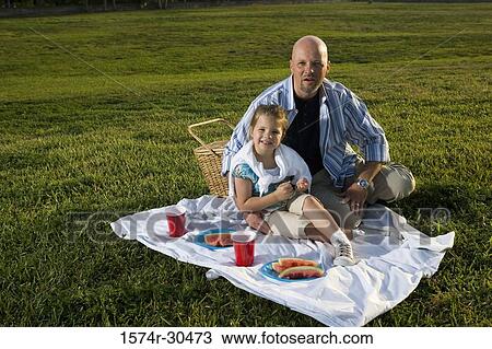 Portrait of father and daughter sitting on a blanket and smiling View Large Photo Image Stock Image - Portrait of father and daughter sitting on a blanket and smiling. Fotosearch
