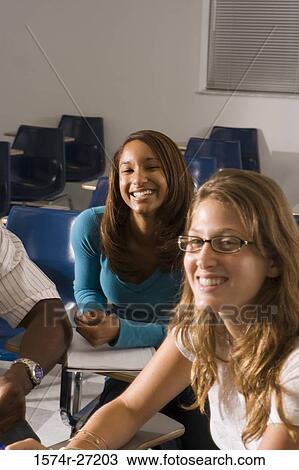 Stock Image - Portrait of female students smiling in the classroom. Fotosearch