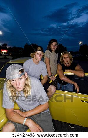 Portrait of friends by a car at the parking area View Large Photo Image Stock Image - Portrait of friends by a car at the parking area. Fotosearch