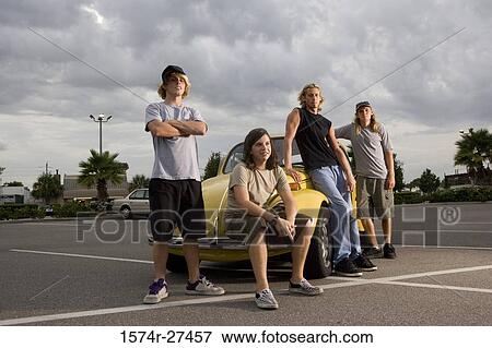 Portrait of friends by a car at the parking area View Large Photo Image Stock Photo - Portrait of friends by a car at the parking area. Fotosearch