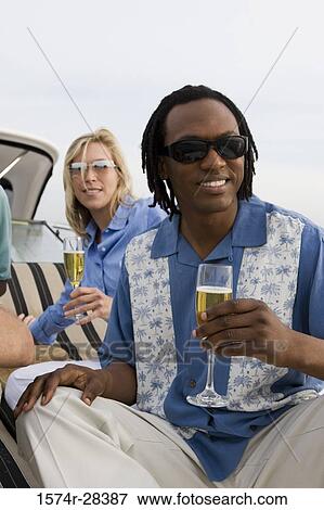 Portrait of friends holding glass of champagne View Large Photo Image Stock Photo - Portrait of friends holding glass of champagne. Fotosearch