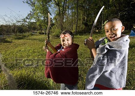 Portrait of friends playing with sword and stick at forest View Large Photo Image Stock Photograph - Portrait of friends playing with sword and stick at forest. Fotosearch