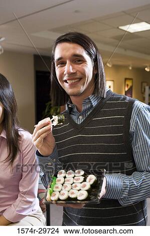 Portrait of friends sitting together and eating food View Large Photo Image Picture - Portrait of friends sitting together and eating food. Fotosearch