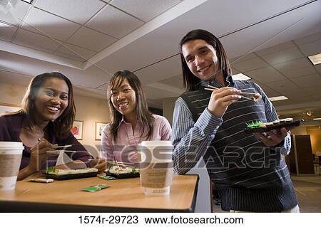 Portrait of friends sitting together and eating food View Large Photo Image Stock Image - Portrait of friends sitting together and eating food. Fotosearch